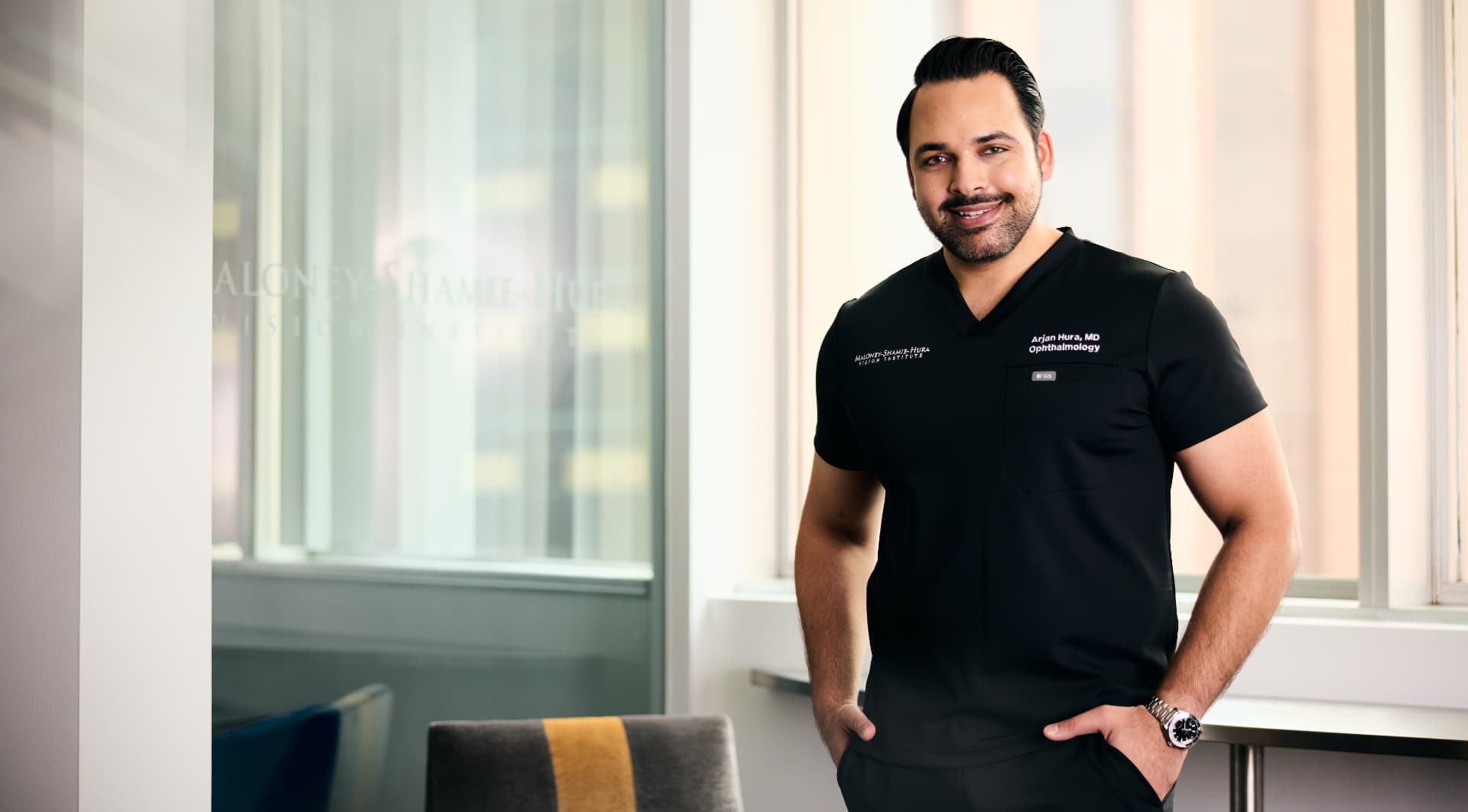 Portrait of Dr. Arjan Hura in the Maloney-Shamie-Hura Vision Institute office